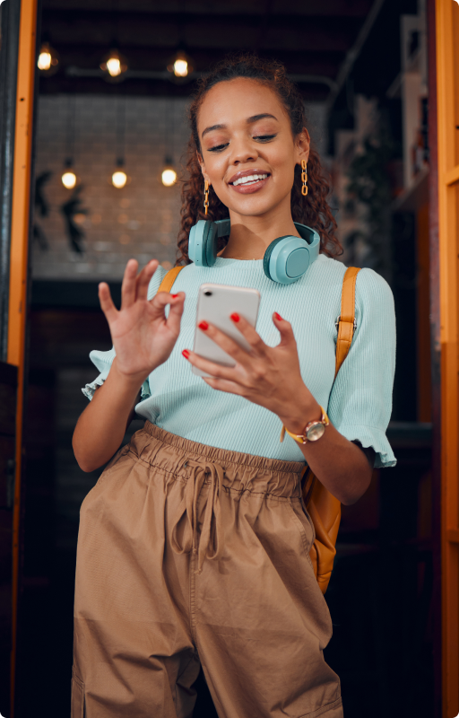 Smiling gen z woman using smartphone, symbolizing varied shopping preferences and behaviors across different generations in 2024